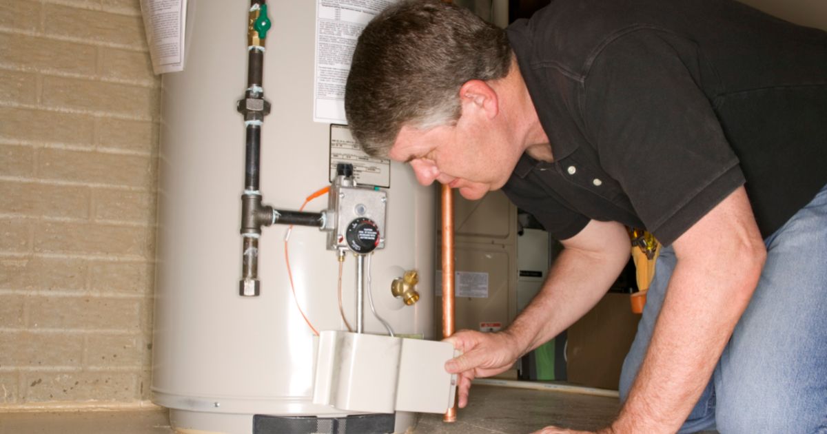 Man checking water heater